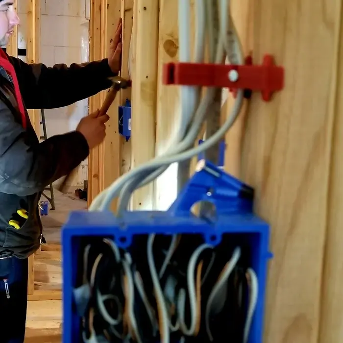 Electrical rough-in wiring run through new wall framing